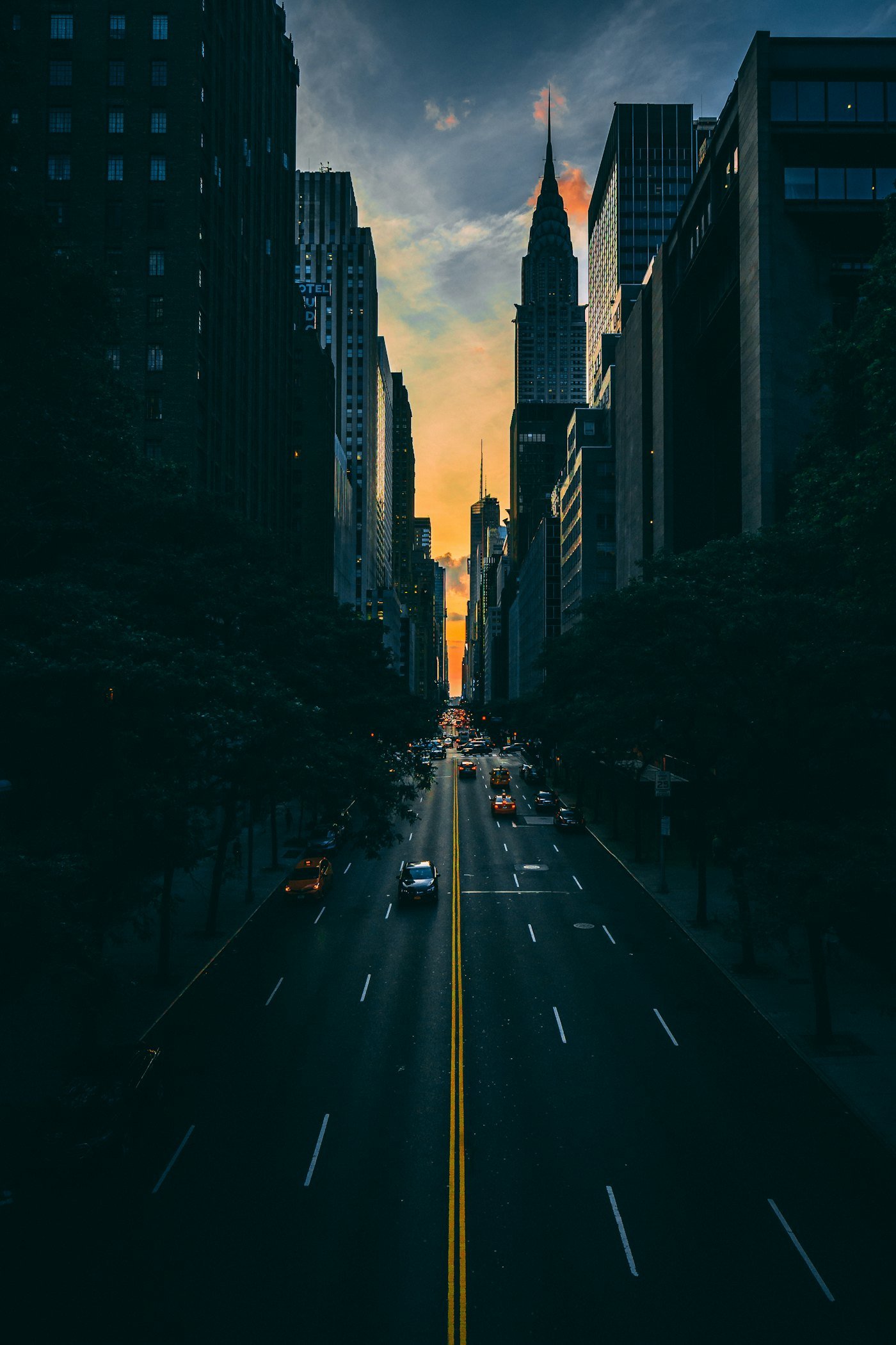 Open road heading towards a city skyline at dusk